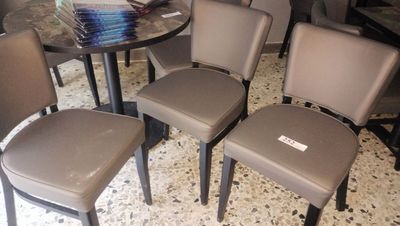 four chairs and a table in a room