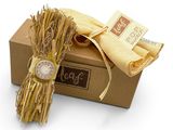 a bundle of straw tied to a box with a watch on it