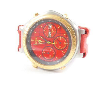 a close up of a red and gold watch on a white surface