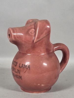 a pink pottery jug with a dog on it