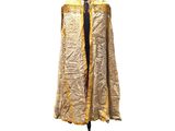 gold and black cape on a mannequin stand on a white background