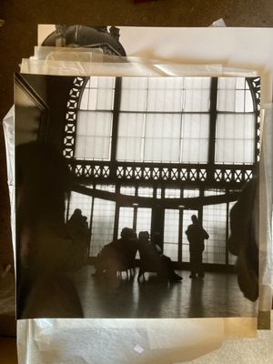 a black and white photo of people in a large building