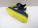 a close up of a pair of blue and yellow shoes on a white surface