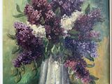 purple and white lilas in a white vase on a green background