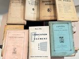 several old books are stacked on top of each other on a table