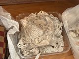 two bags of yarn sitting on the floor next to each other