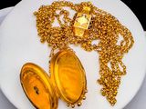 a white plate with a gold locke and a chain on it
