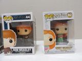 two pop vinyl figures of ron weasley and ginny weasley from harry potter