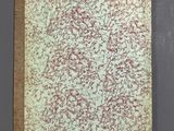 an old book with red and green paint on it