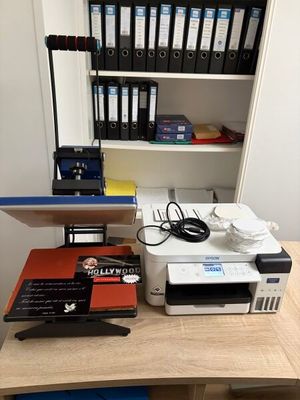 a desk with a printer, printer and other office supplies on it