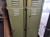 two green lockers sitting next to each other in a room