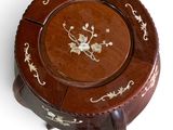 a small wooden plate with a floral design on it