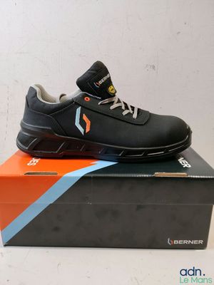 a pair of black shoes on top of a box