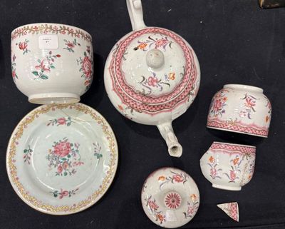 a tea pot, cup, saucer, and saucer sitting on a table