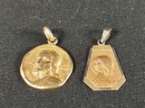 two gold pendants depicting the face of jesus and mary