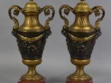 pair of antique bronze and black vases on red marble bases