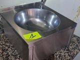 a stainless steel sink with a yellow sticker on it
