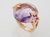 a close up of a ring with an amethorate and a star