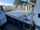 a white truck that is parked next to a white van