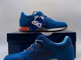 a pair of blue and red sneakers sitting on top of a box