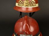 a red fireman ' s helmet with a light on it