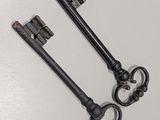 two old keys that are sitting on top of a table