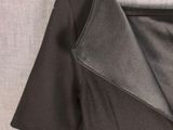a close up of a dress on a hanger on a wall