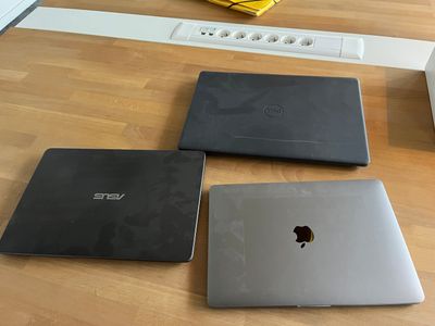three laptops sitting on the floor next to each other