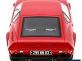 a red car that is sitting on a white surface