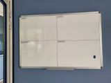 a white board on the wall in a room