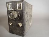 an old camera sitting on a table with a white background