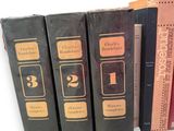 books are lined up in a row on a white surface
