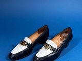 a pair of black and white shoes on a blue background
