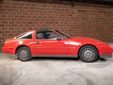 an image of a red car parked in front of a brick wall