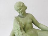 a statue of a woman with a dog on her lap