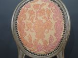 a close up of a chair with a floral pattern on it