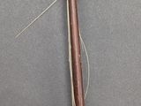 a close up of a piece of wood with a needle