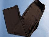 dark brown pants on a blue surface with a blue background