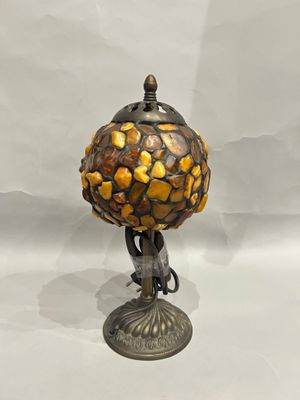 a close up of a lamp on a table with a white background