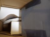 a box with a bed inside of it on the floor