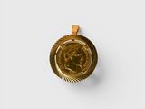 a close up of a gold coin on a white surface