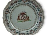 a plate with a picture of a horse and carriage on it
