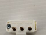 a close up of a small white electrical device on a table