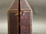 a small brown suitcase with two open doors