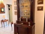 a china cabinet in the middle of the room