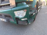 a green truck that is parked in the parking lot