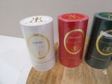 three tins of red, white, and green are sitting on a table