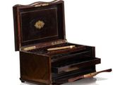 a small wooden box with a drawer on top of it
