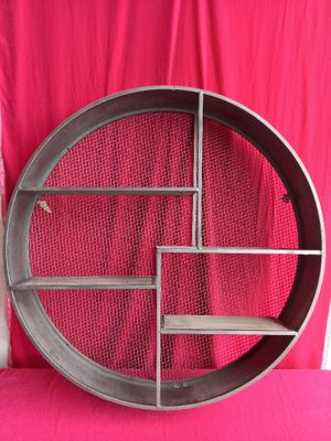 a picture of a metal shelf on a pink background