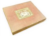 an old book with a picture on it on a white surface